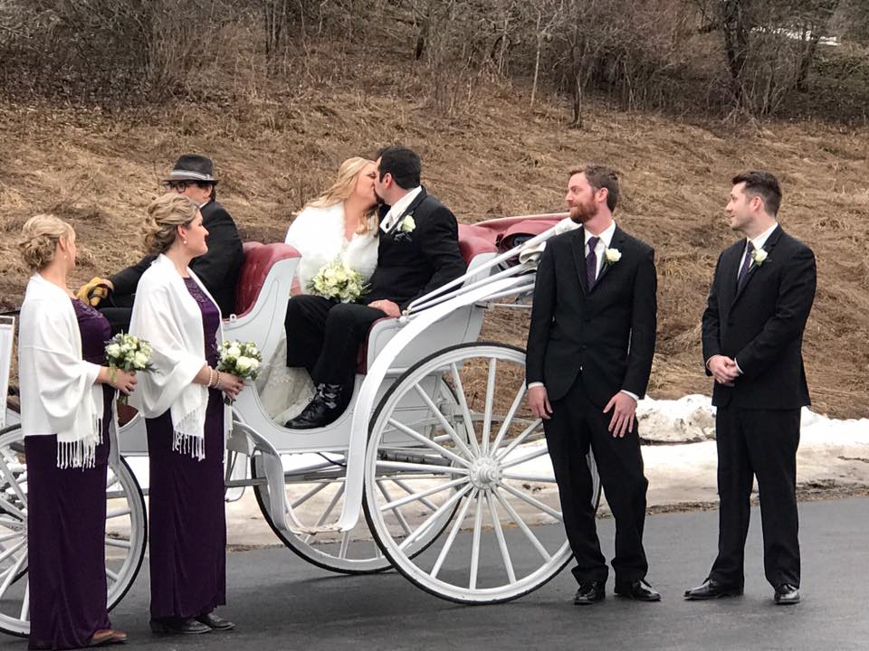 Wedding couple with horse-drawn carriage at ceremony
