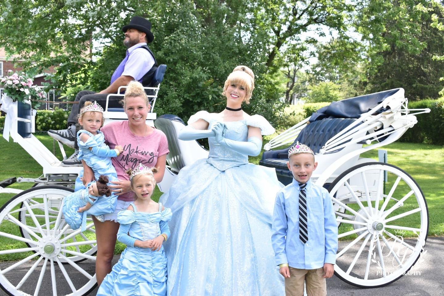 Children enjoying a princess carriage ride in a sunny park